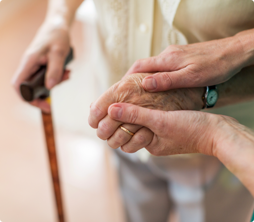 Elderly holding hands.